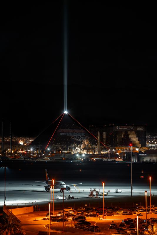 luxor casino at night with a plane in foreground 