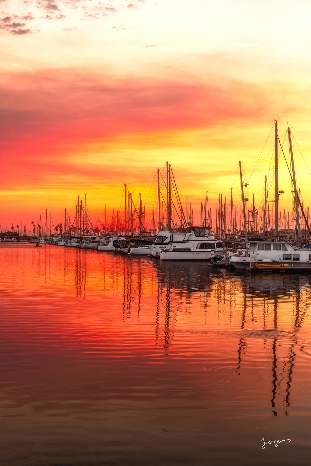 boats in the marina during red and orange sunset 