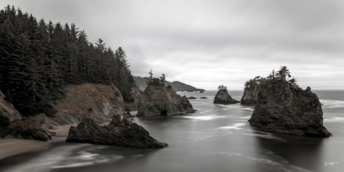 Oregon coast with individual rock islands on a cloudy day with monochrome art by Eddie Jongas