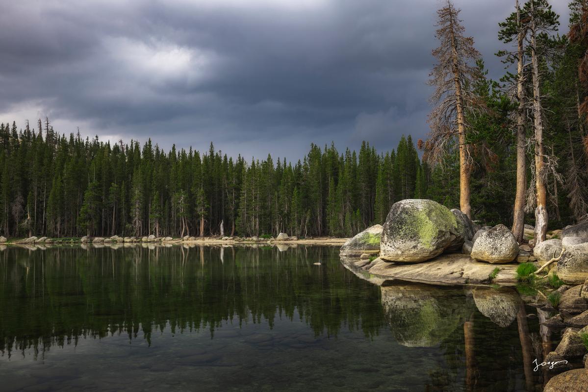 lake tenaya yosemite pine forest next to granite boulders