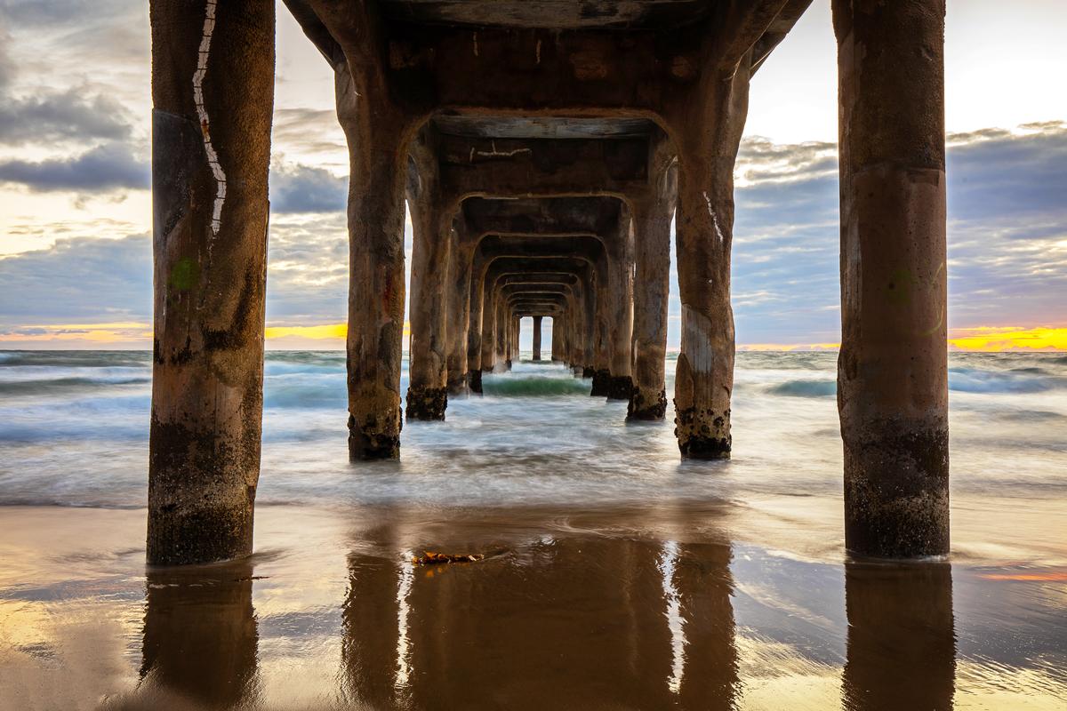 manhattan beach pier during sunset ocean waves 